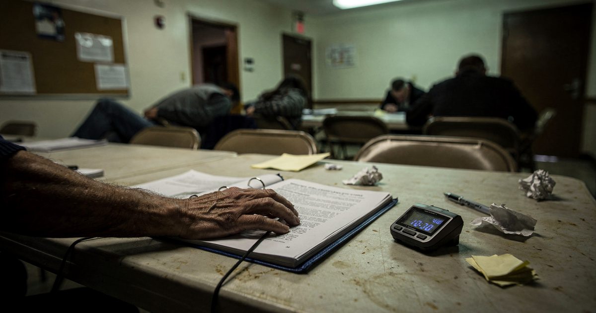 Close detail at 3am under a single fluorescent tube in a parish hall, a hand cropped at the wrist resting on an open ring binder of bylaws beside a stopwatch.
