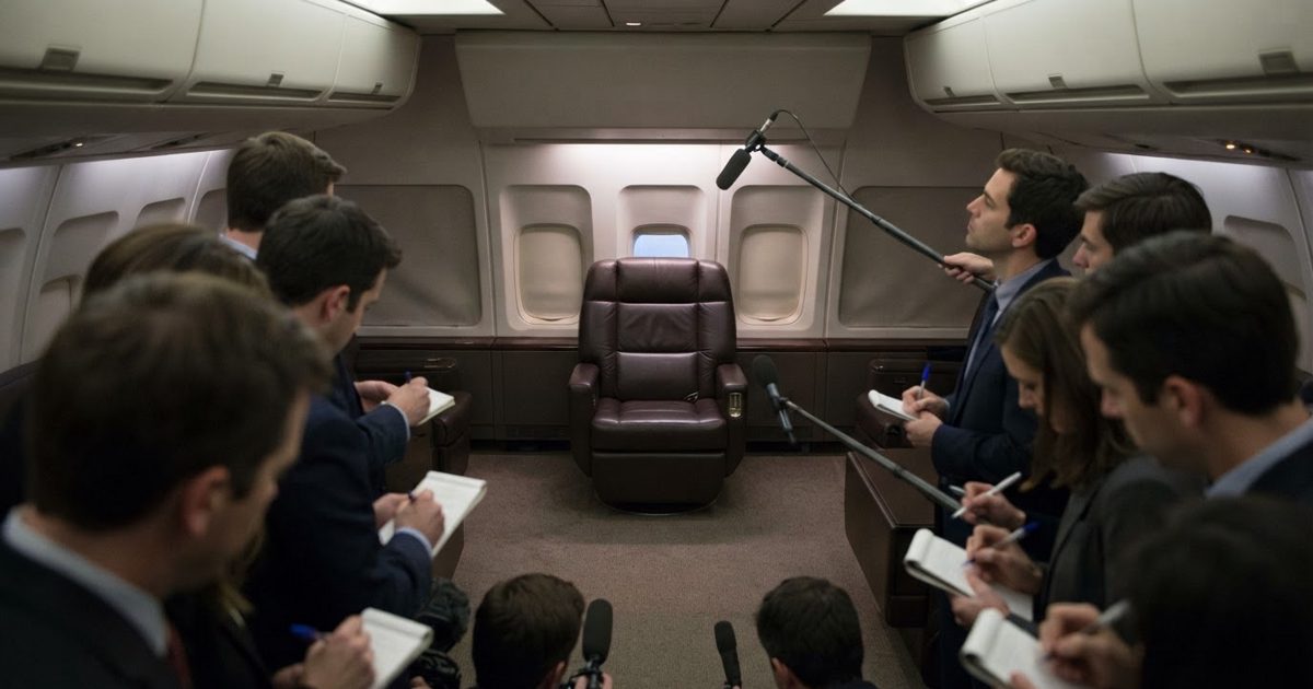 A wide shot inside a lavish, empty airplane cabin with a single large leather swivel chair at the center, while blurred figures of journalists in the.